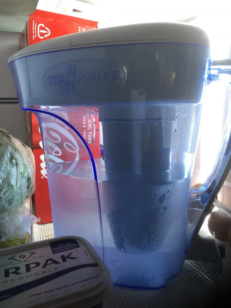 Water filter sat on fridge shelf