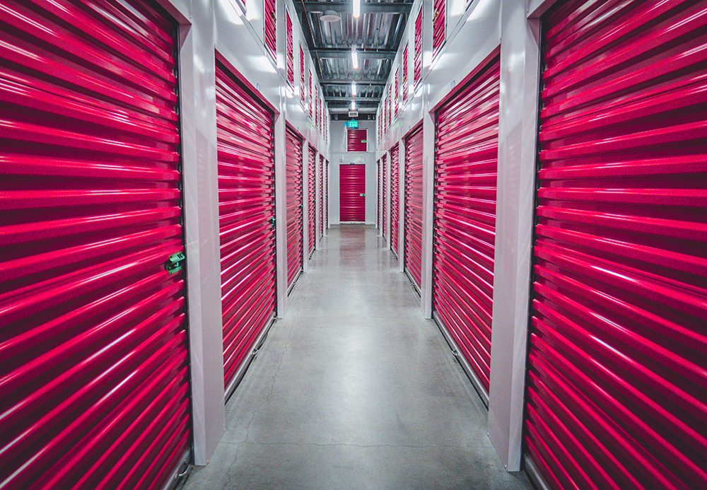 Rows of pink shutters in a self-storage unit