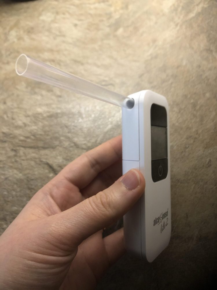 White Breathalyser with blow tube inserted