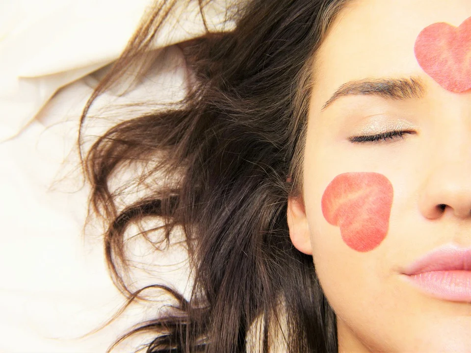 Women with red heart on cheek