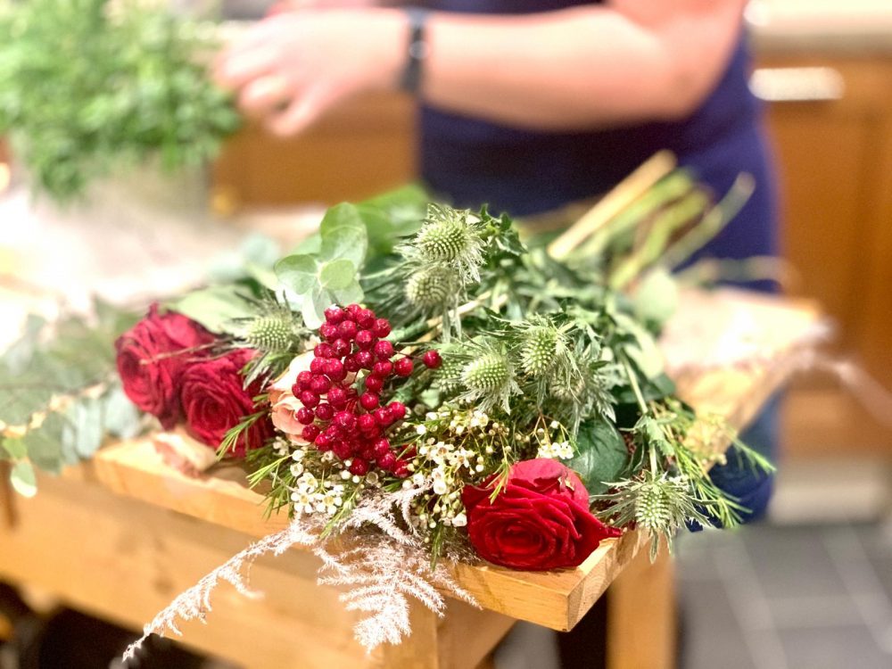 Bunch of red roses laying on a table
