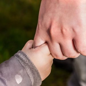 Childs hand holding an adults hand