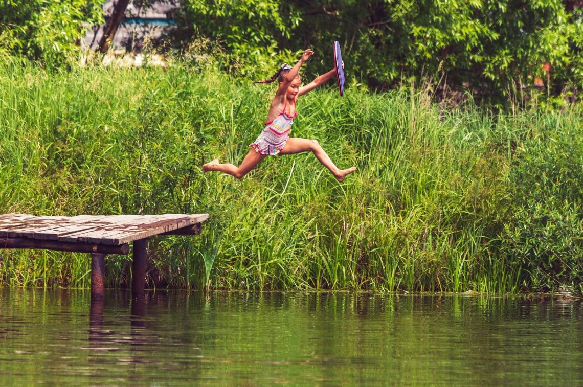 Child jumping into river